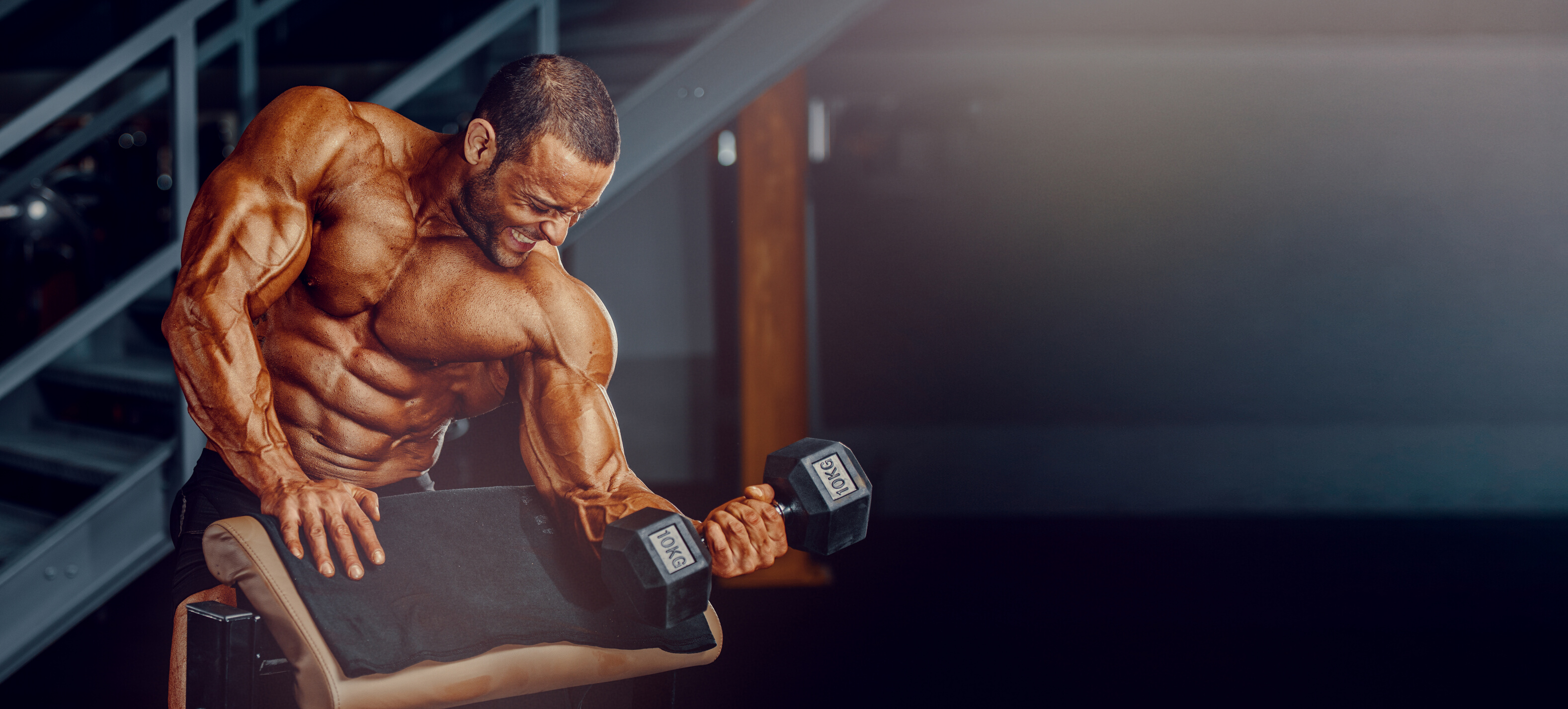 Bodybuilding Workout. Handsome Bodybuilder Training at the Gym. Copy Space